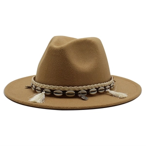 Detailed view of camel wool hat with shell accents and woven ethnic decorative band