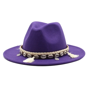 Detail of purple wool felt jazz hat with shell ornaments and white fringe tassels
