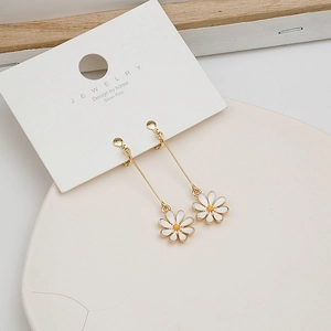 Close-up of long daisy drop earrings with gold chains and S925 silver posts on white card