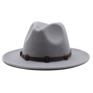 Detail of light grey wool fedora hat featuring a brown leather band and metal buckles