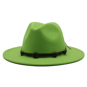 Detail of bright green wool fedora hat with brown leather band and decorative buckles