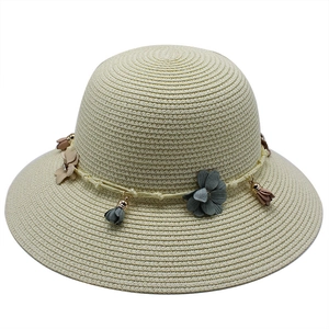 Summer beige straw sun hat with floral fabric accents and tassel for outdoor beach trips