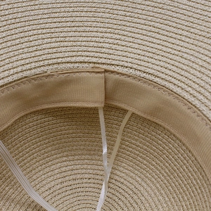 Detail of hand-woven straw hat interior with adjustable drawstring and sweatband