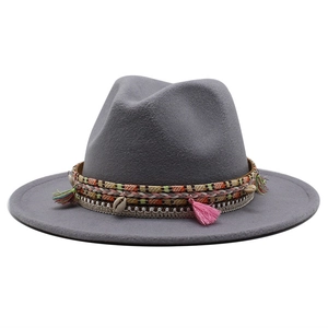 Detail of wool fedora featuring bohemian braided band with colorful tassels and shells