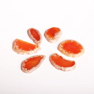 Macro view of six irregular orange agate slices with natural textures and crystal edges