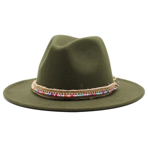 Detail of olive green fedora hat featuring beaded trim, rhinestone chain, and hemp rope