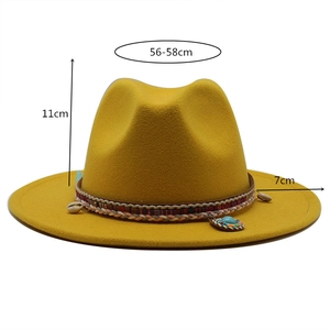 Detail of yellow wool fedora with ethnic woven band, shell decor and turquoise stone