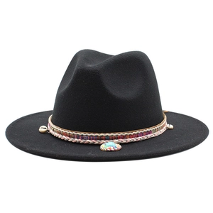 Detail of black wool fedora featuring ethnic woven band with shells and turquoise pendant