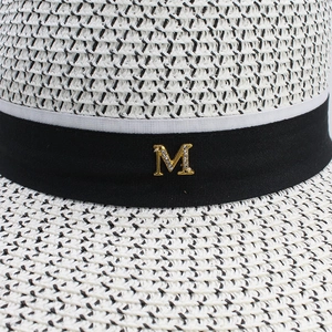 Elegant wide-brim straw sun hat with black ribbon and rhinestone M emblem for beach vacation