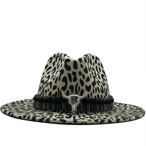 Close-up of leopard print fedora with ethnic strap and silver bull head metal ornament
