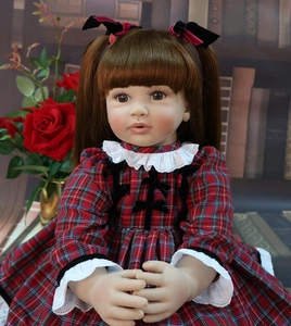 Close-up of 60cm reborn doll with brown pigtails in red plaid lace dress