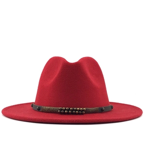Red wool fedora hat with a wide brim featuring a studded belt and classic indented crown