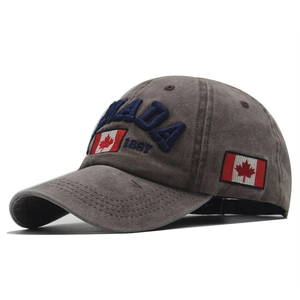 Detailed close-up of Canada 1867 embroidery and flag patch on a brown cotton baseball cap