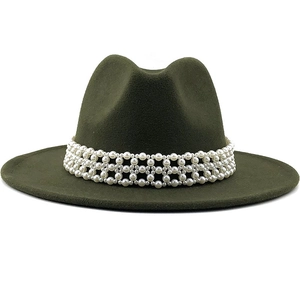 Detail shot of elegant dark green wool fedora hat featuring a white pearl beaded band