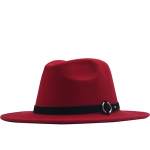 Detail of red wool fedora with wide flat brim and black band featuring silver metal rings
