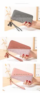 Detailed views of long contrast-color patchwork wallets with glitter and wrist straps