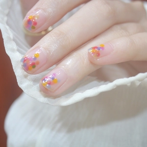 Short square press-on nails with colorful candy dots on a clear base, fresh summer style