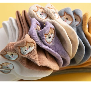 Close-up of colorful cotton ankle socks featuring cute embroidered cat patterns
