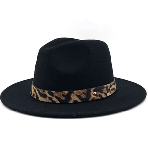 Detail of black wool fedora featuring a leopard print band and gold metal hardware