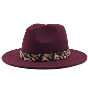 Macro shot of the burgundy wool fedora featuring leopard print band and metal stud