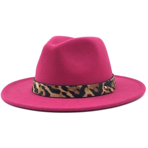 Detail of rose red fedora hat featuring a leopard print band and gold stud accent