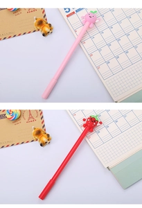 Detail shot of cute fruit gel pens with silicone toppers in pink and red colors