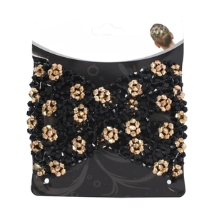 Detailed view of magic hair comb with black and gold beads on product display card