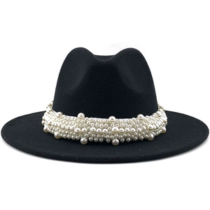 Detail of elegant black wide-brim felt hat with layered pearl trim and minimalist design