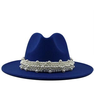 Close-up of royal blue fedora hat featuring a wide brim and elegant white pearl band