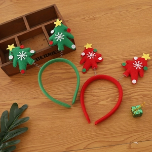 Festive Christmas tree headbands in red and green colors on a rustic wooden background