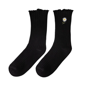 Black mid-calf cotton socks with daisy embroidery and elegant ruffled lace cuffs