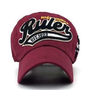 Macro detail of high quality Ruler embroidery on burgundy cotton washed baseball cap