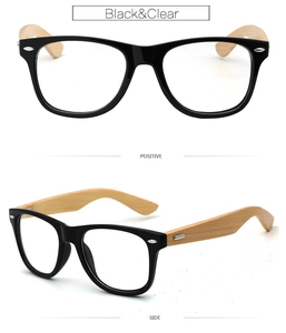 Detail view of black frame eyewear with natural bamboo temples and clear lenses