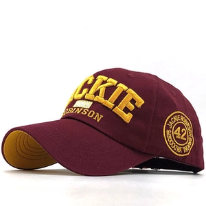 Detail of burgundy baseball cap with yellow Jackie Robinson 42 embroidery and cotton texture