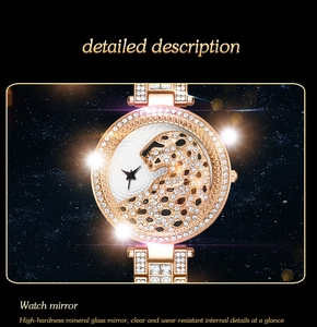 Macro shot of luxury gold watch dial with crystal leopard head and mineral glass mirror