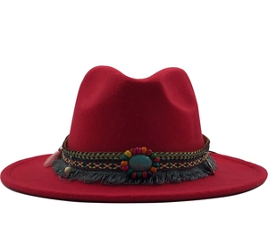 Detailed view of red wide brim fedora with ethnic turquoise beaded band and grey tassel