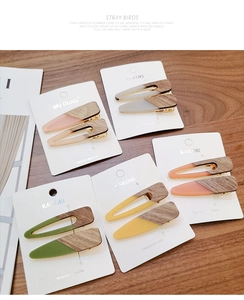 Detailed view of wood texture candy-colored triangular hair clips on display card