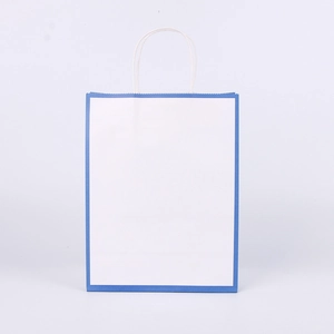 Close-up of a white kraft paper shopping bag with blue border detailing and paper handles