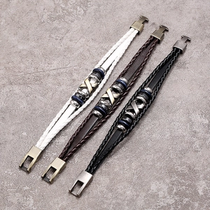 Three multi-layer braided leather bracelets in black, brown and white with metal X-studs