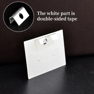 White plastic adhesive hang tab for retail packaging with a round hole for display hanging