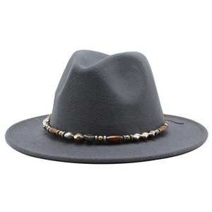 Detail of dark grey wool fedora hat featuring an intricate beaded band with wood and metal beads