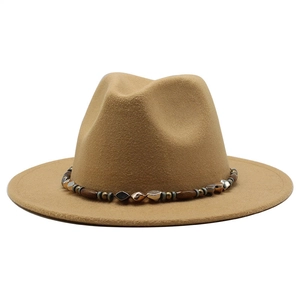 Detailed close-up of camel wool fedora hat with ethnic beaded band and wooden accents