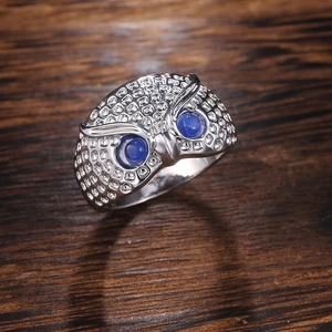 Vintage silver owl ring featuring intricate mesh texture and vibrant blue gemstone eyes