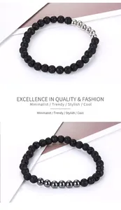 Detail of black lava stone beads with silver and gunmetal steel accents on a stretch bracelet