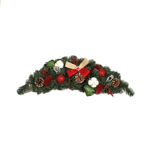 Christmas door swag with pine cones, cotton balls, and red bows on white background