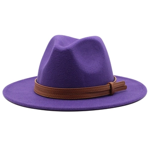Detail of purple wool felt fedora hat featuring brown leather belts and a metal buckle