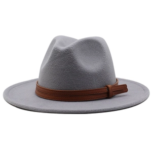 Detail of light grey wool fedora hat featuring a brown leather band and metal buckle strap