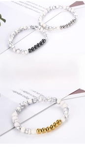 Detail of white turquoise beaded bracelets with gold, silver and gunmetal accents
