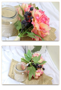 Detail of faux peony and blueberry wedding bouquet with elegant ribbon binding