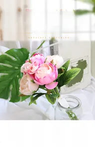 Realistic pink faux Persian buttercup bouquet with silk petals and green leaves for decor